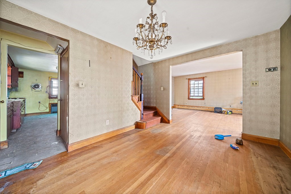 16 Magdala Street Boston, MA 02124 - Photo 11 of 22 a view of a livingroom with wooden floor and a chandelier