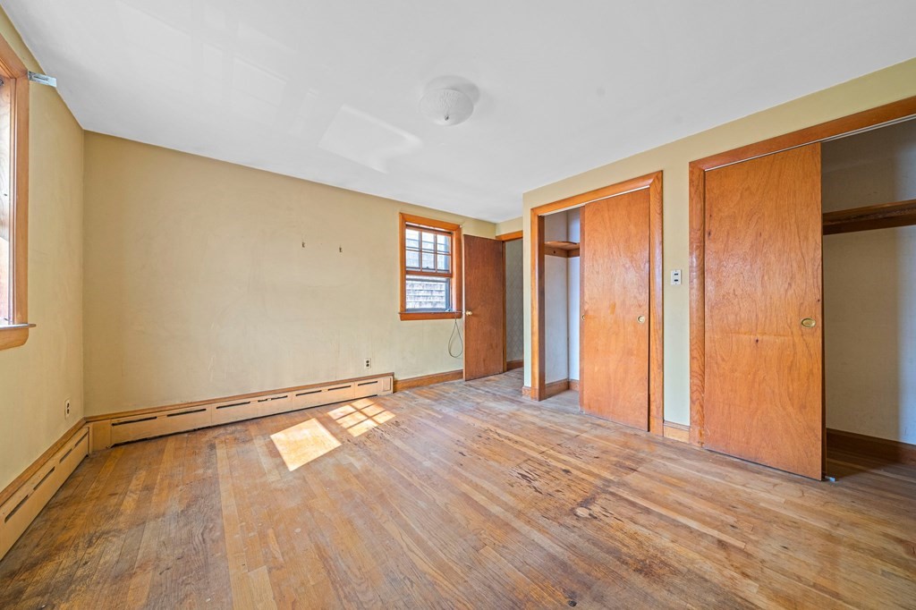16 Magdala Street Boston, MA 02124 - Photo 13 of 22 a view of an empty room with wooden floor and a window