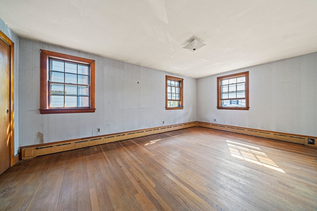 16 Magdala Street Boston, MA 02124 - Photo 14 of 22 an empty room with wooden floor and windows