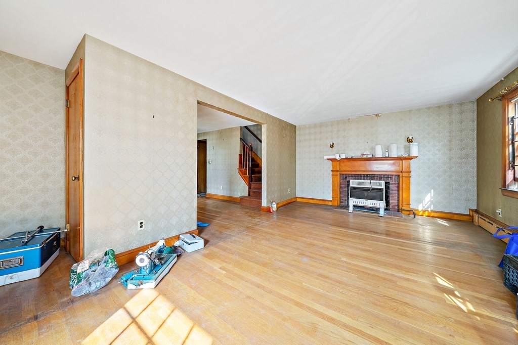 16 Magdala Street Boston, MA 02124 - Photo 6 of 22 a view of livingroom with furniture and a fireplace