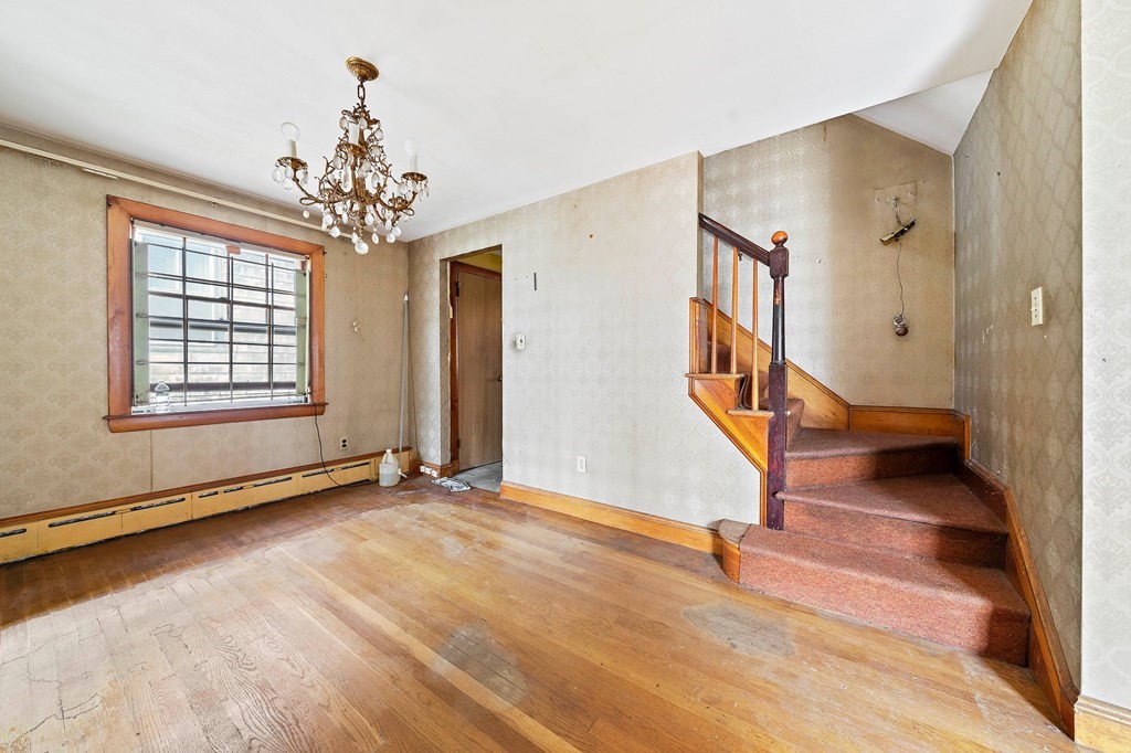 16 Magdala Street Boston, MA 02124 - Photo 8 of 22 a view of an empty room with staircase and window