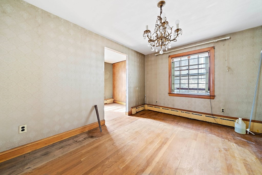 16 Magdala Street Boston, MA 02124 - Photo 9 of 22 a view of an empty room with window and wooden floor