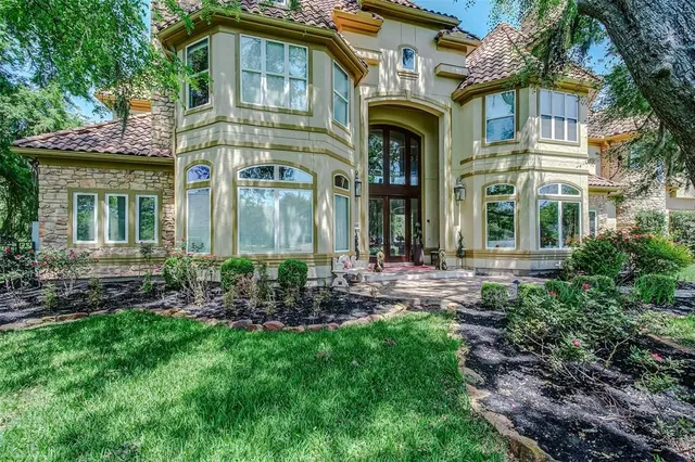 a front view of a house with yard and outdoor seating