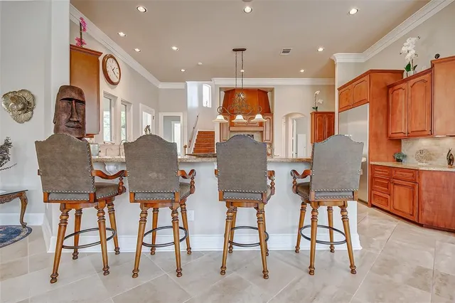a kitchen with stainless steel appliances granite countertop a sink a oven and a refrigerator
