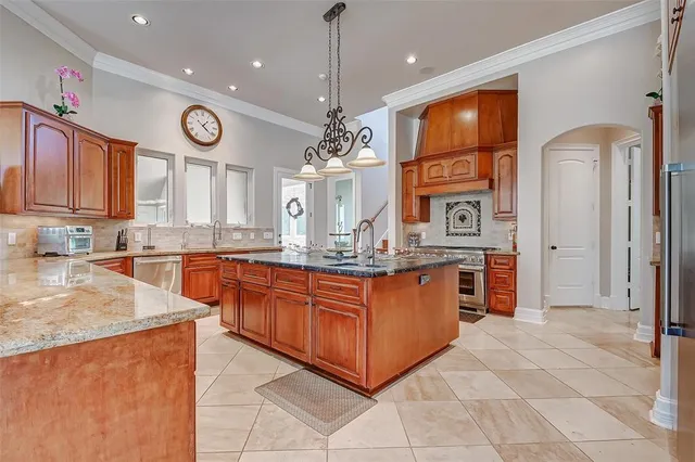 a kitchen with stainless steel appliances granite countertop a stove and a sink