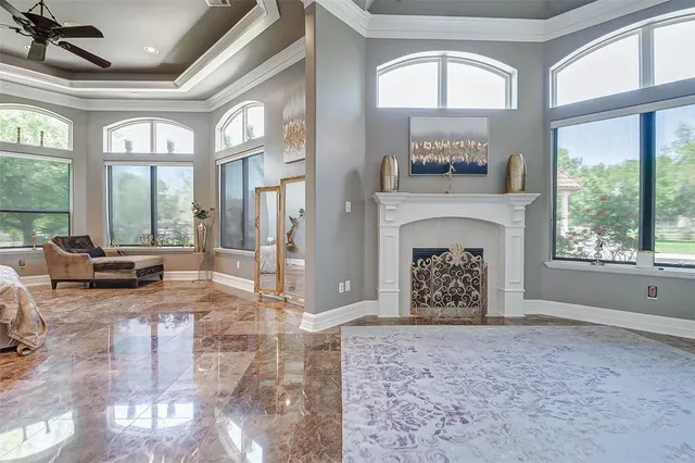 a living room with a fireplace and a large window