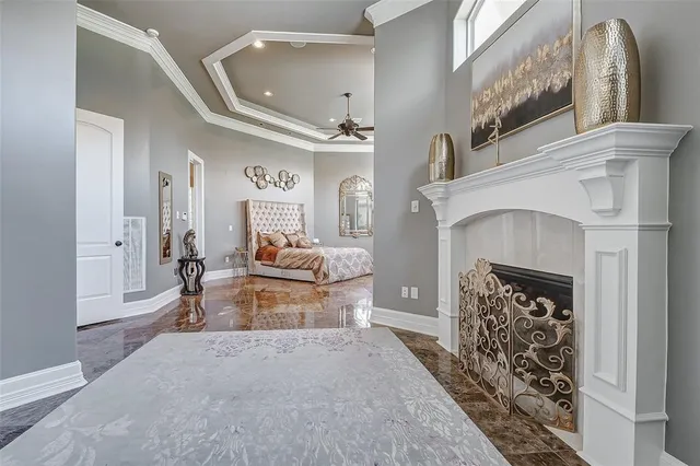 a spacious bedroom with a bed and glass windows