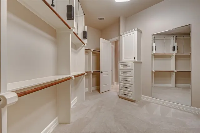 a living room with furniture a chandelier and a dining table with wooden floor