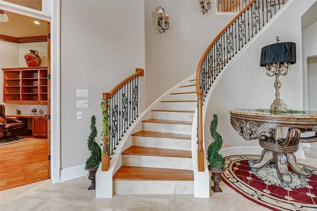 a living room with stainless steel appliances kitchen island a table and chairs in it