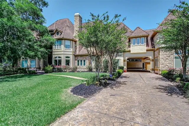 a front view of a house with a garden and yard