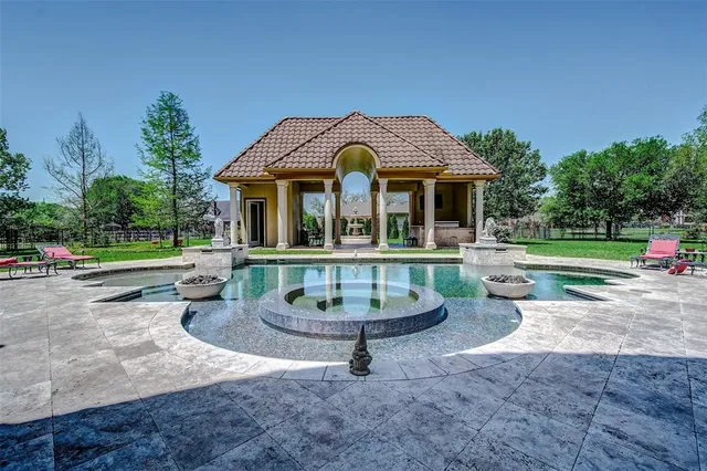 a front view of a residential houses with yard and green space