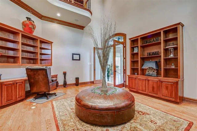 a living room with fireplace furniture and a large window