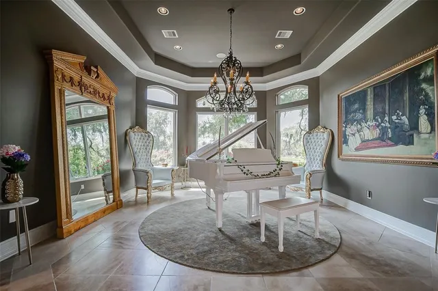 a dining room with furniture a chandelier and wooden floor