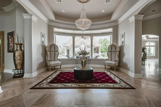 a dining room with furniture and a kitchen view