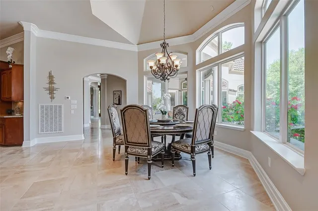 a large kitchen with stainless steel appliances granite countertop a stove oven a sink dishwasher and cabinets with wooden floor