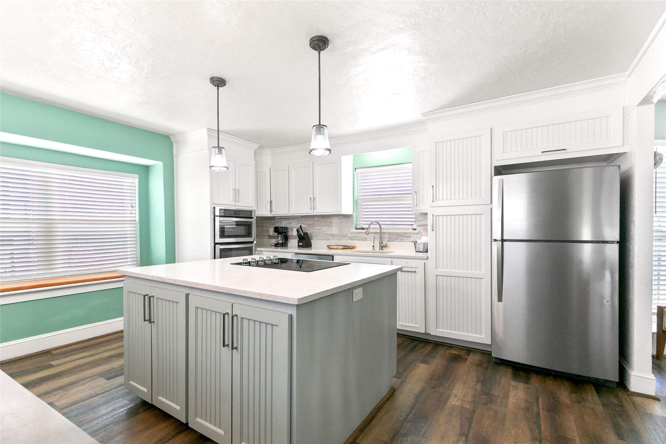 319 Pompano Lane Surfside Beach, TX 77541 - Photo 13 of 48 a kitchen with refrigerator cabinets and wooden floor