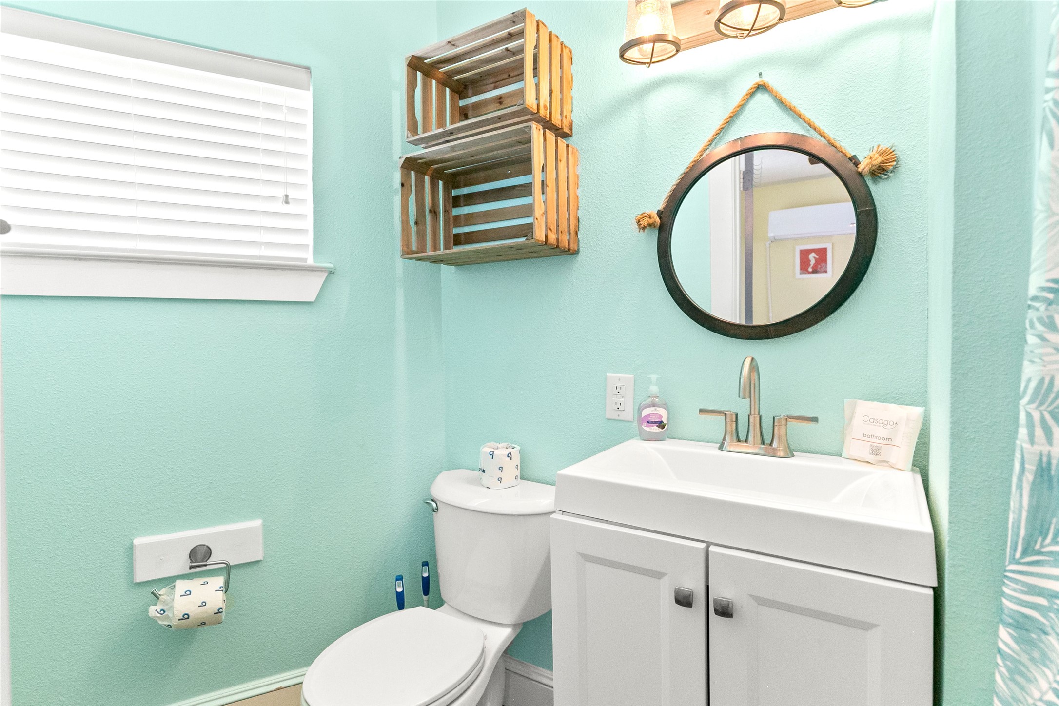 319 Pompano Lane Surfside Beach, TX 77541 - Photo 28 of 48 a bathroom with a toilet a sink and a mirror
