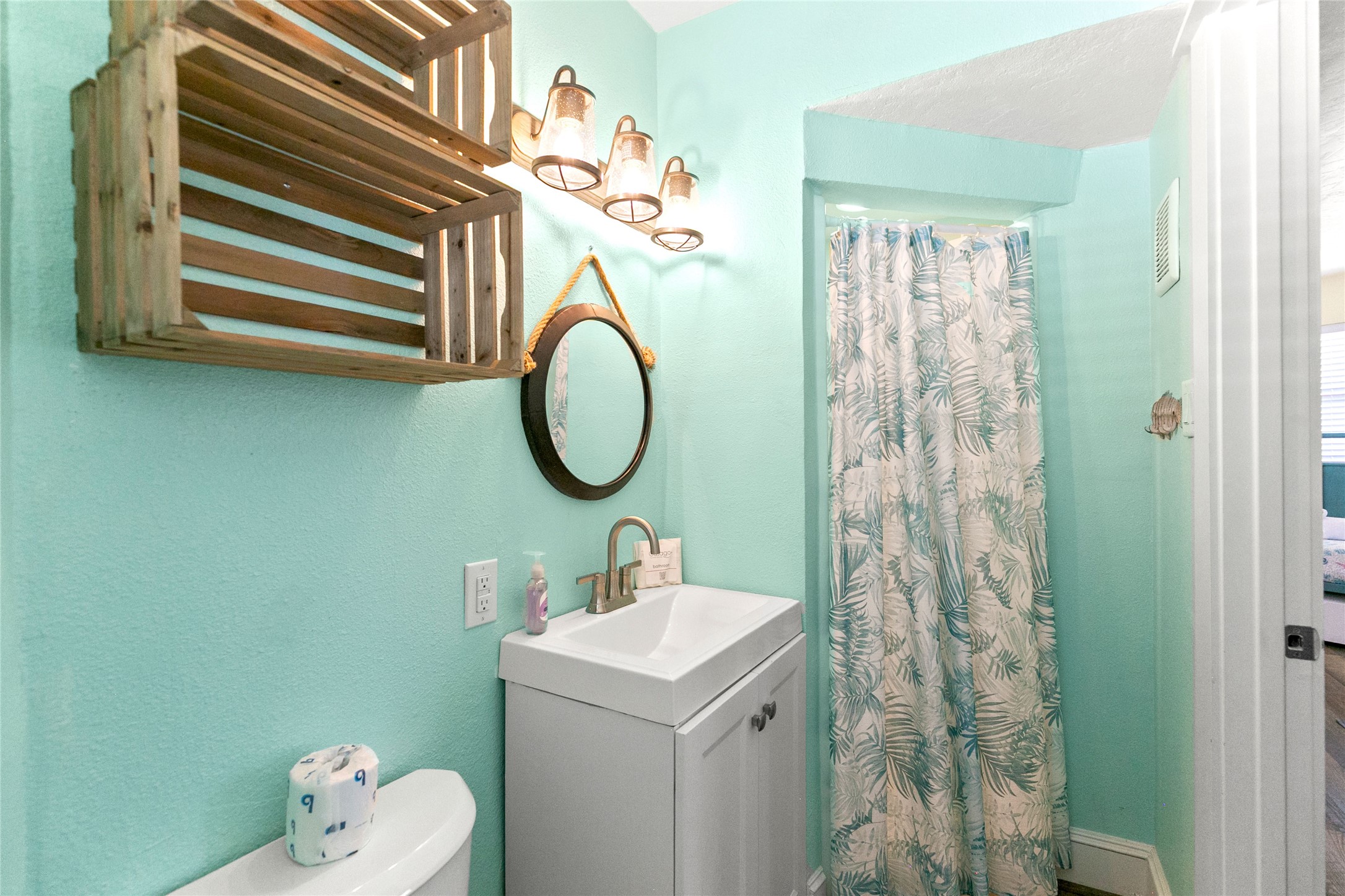 319 Pompano Lane Surfside Beach, TX 77541 - Photo 29 of 48 a bathroom with a sink a mirror and a toilet
