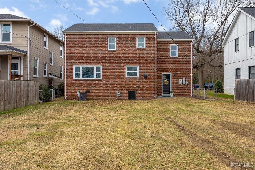 2601 Brook Road Richmond, VA 23220 - Photo 27 of 28 Back of property with a fenced backyard, cooling u