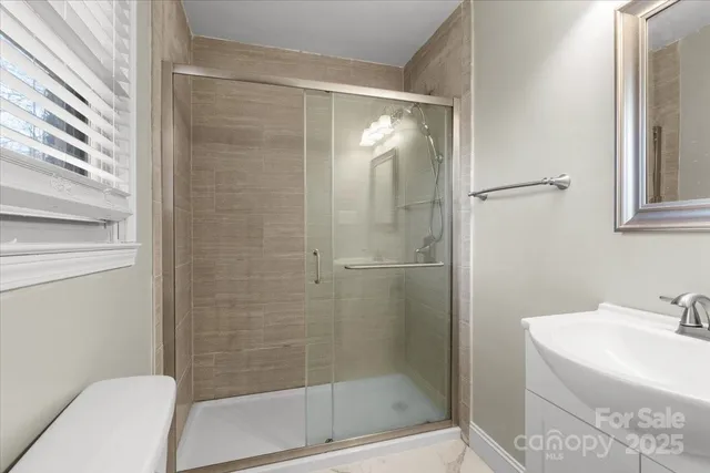 a bathroom with a shower and a sink