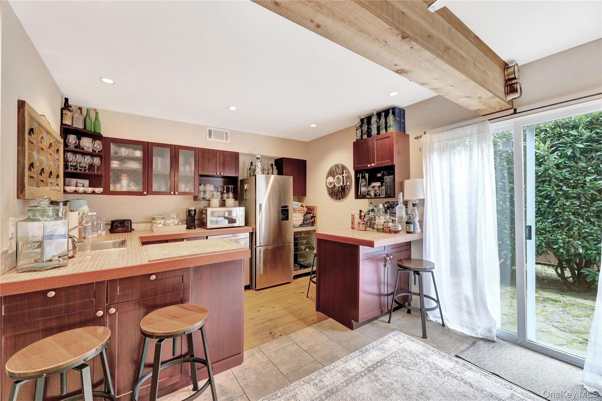 198 South Country Road Remsenburg, NY 11960 - Photo 38 of 49 a kitchen with stainless steel appliances granite countertop a refrigerator and a stove top oven