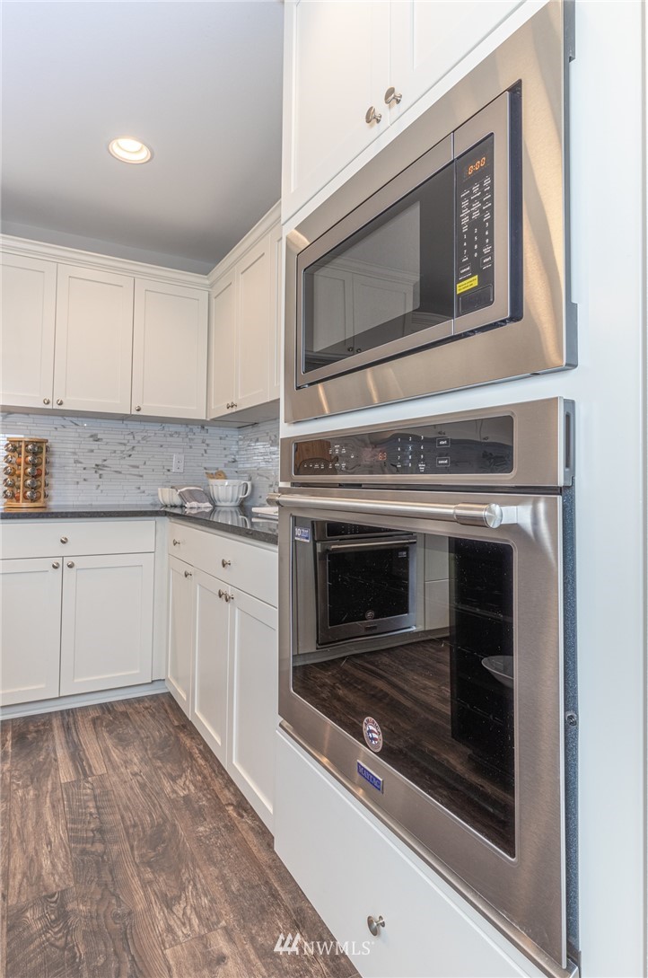 613 Index Avenue Northeast Renton, WA 98056 - Photo 12 of 32 a kitchen with granite countertop white cabinets stainless steel appliances and sink