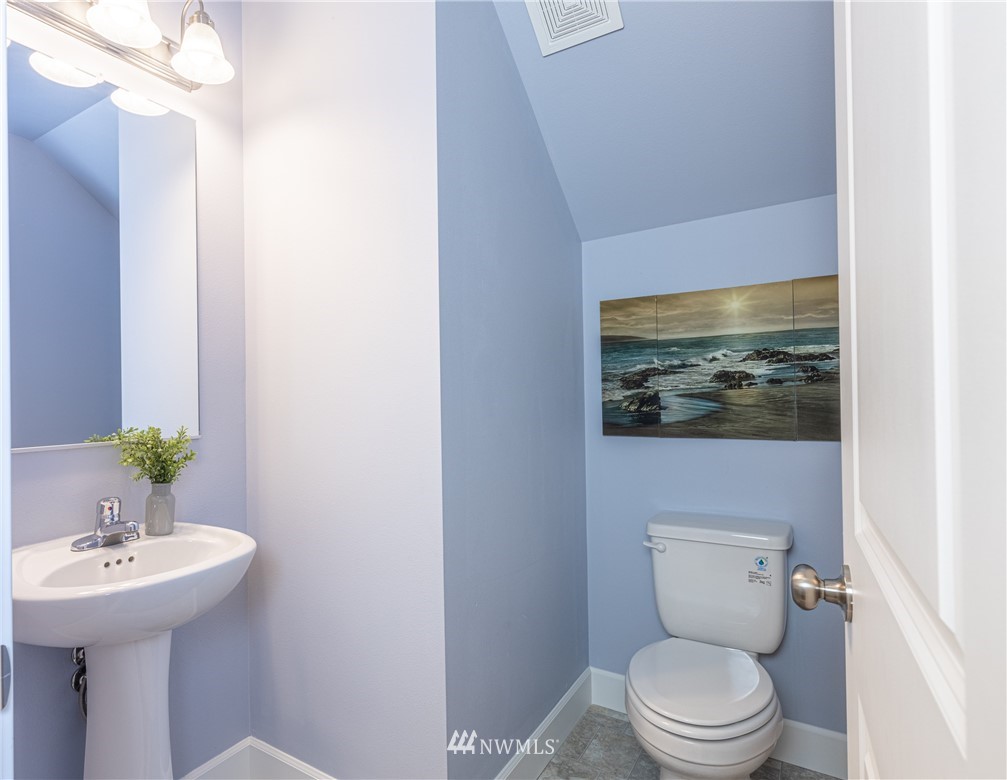613 Index Avenue Northeast Renton, WA 98056 - Photo 16 of 32 a bathroom with a toilet a sink and mirror