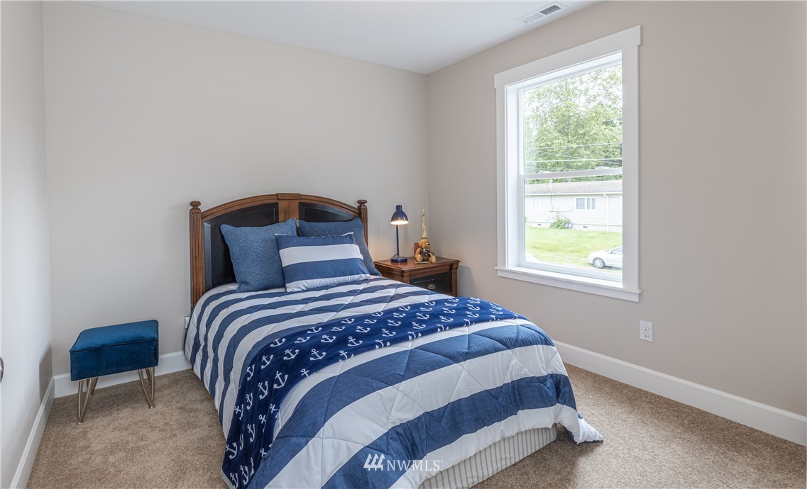 613 Index Avenue Northeast Renton, WA 98056 - Photo 19 of 32 a bedroom with a bed and a window