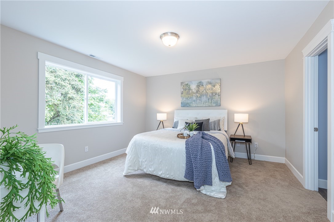 613 Index Avenue Northeast Renton, WA 98056 - Photo 21 of 32 a spacious bedroom with a bed and a window
