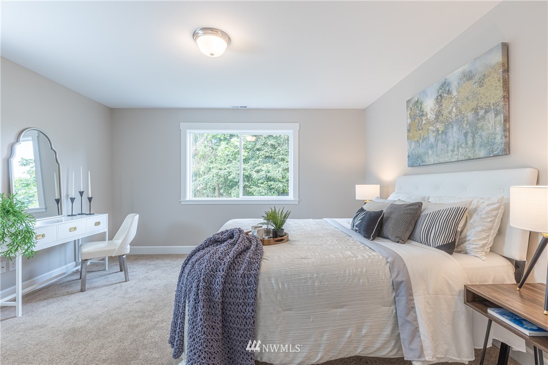 613 Index Avenue Northeast Renton, WA 98056 - Photo 23 of 32 a bedroom with a bed and a painting on the wall