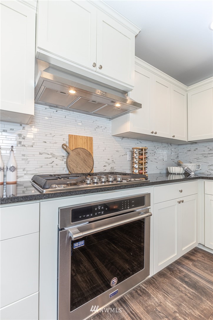 613 Index Avenue Northeast Renton, WA 98056 - Photo 8 of 32 a stove top oven sitting inside of a kitchen