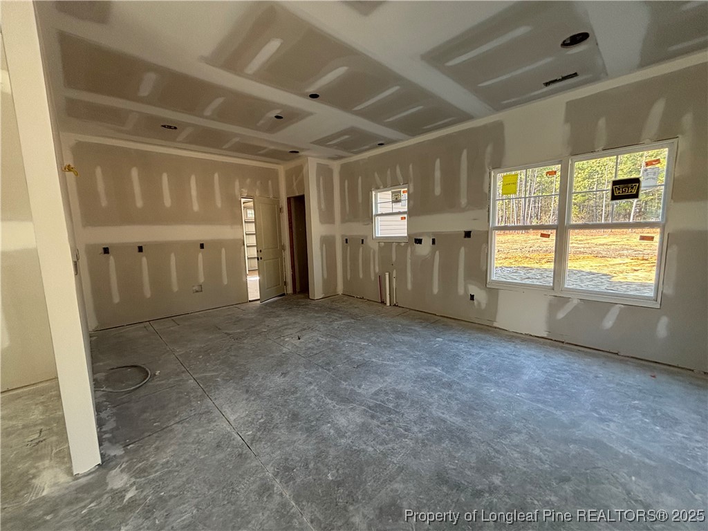 2918 Calloway Road Raeford, NC 28376 - Photo 6 of 13 a view of an empty room with a fireplace and a window