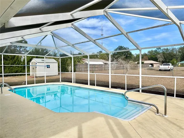 a view of a backyard with a swimming pool