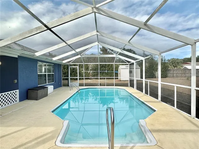 a view of a swimming pool with a patio