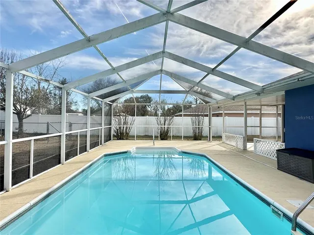 a view of a swimming pool with a patio