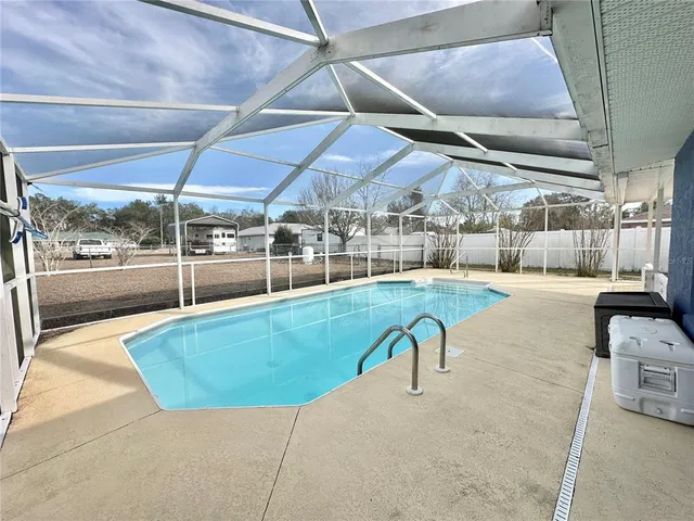 a view of a swimming pool with a patio