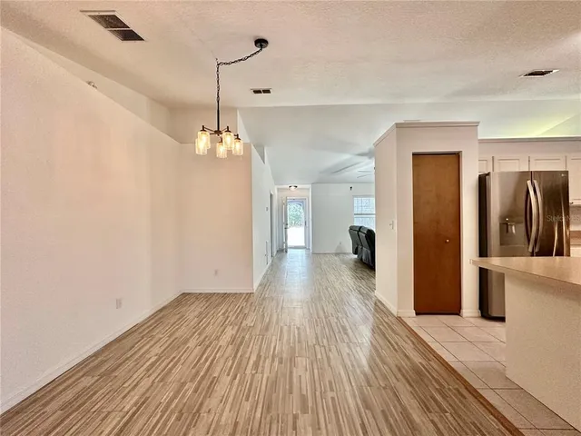 a view of a living room with wooden floor