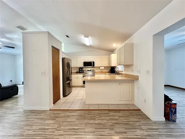 a view of a kitchen with wooden floor