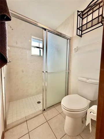 a bathroom with a toilet and a shower