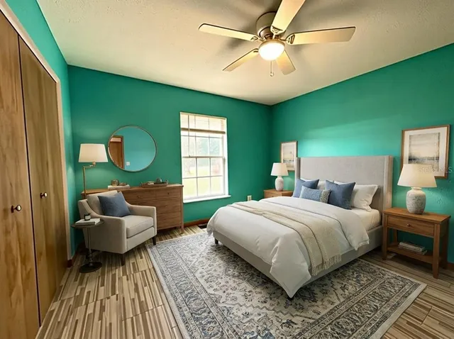 a bedroom with a bed and a mirror on the dresser