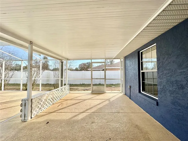 a room with a balcony and large windows