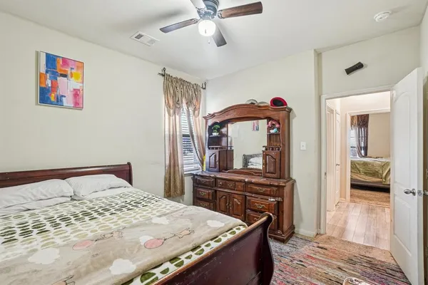 a bedroom with a bed and a dresser