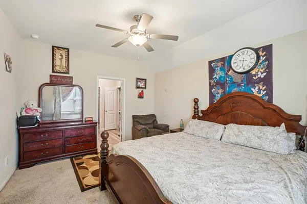 a bedroom with a bed and cabinet