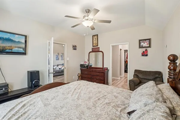 a bedroom with a bed and wooden floor