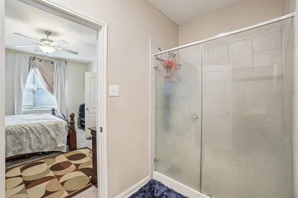 a bedroom with a bed and a mirror