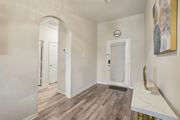 a view of a room with wooden floor and window