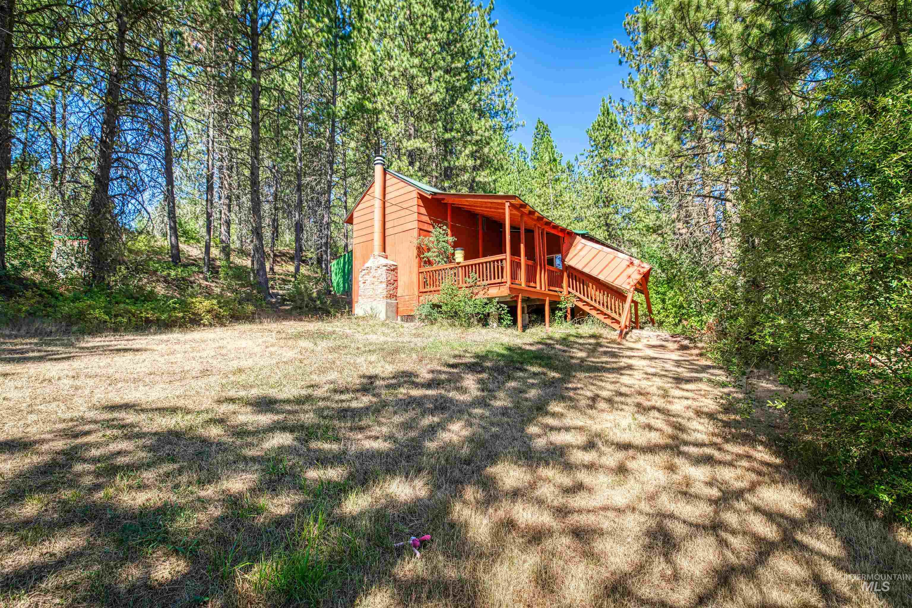 175 Ranft Road Placerville, ID 83666 - Photo 17 of 28 View of side of property featuring a wooden deck and a lawn