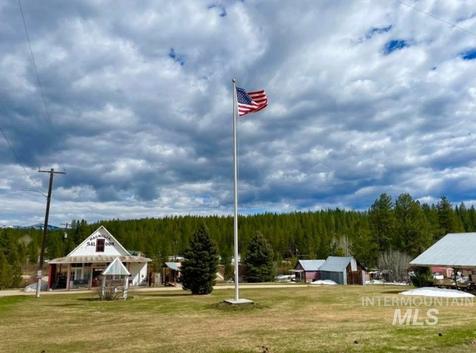 175 Ranft Road Placerville, ID 83666 - Photo 24 of 28 View of playground featuring covered porch, a lawn, and a wooded view