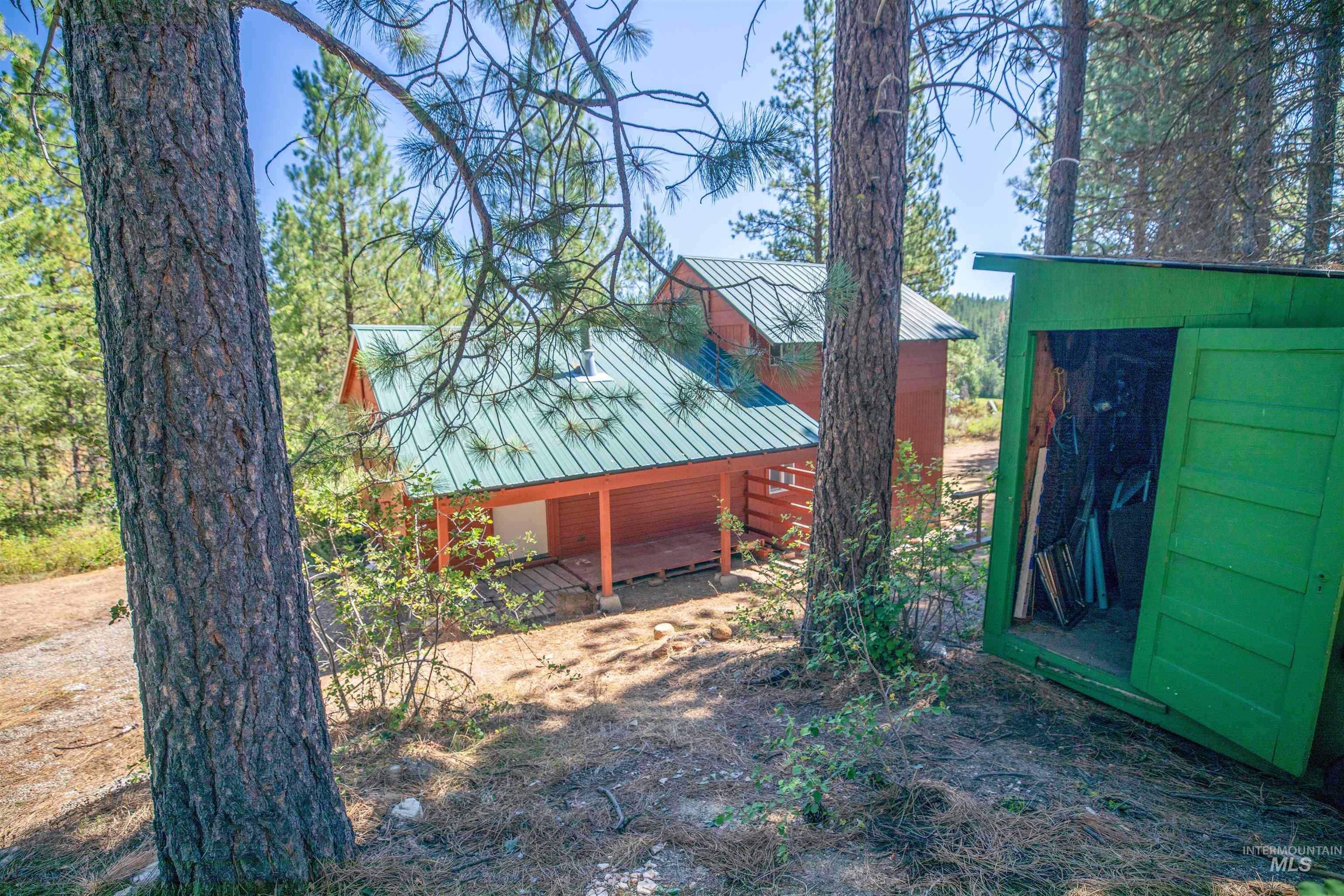 175 Ranft Road Placerville, ID 83666 - Photo 5 of 28 View of home's exterior with a metal roof and a storage shed
