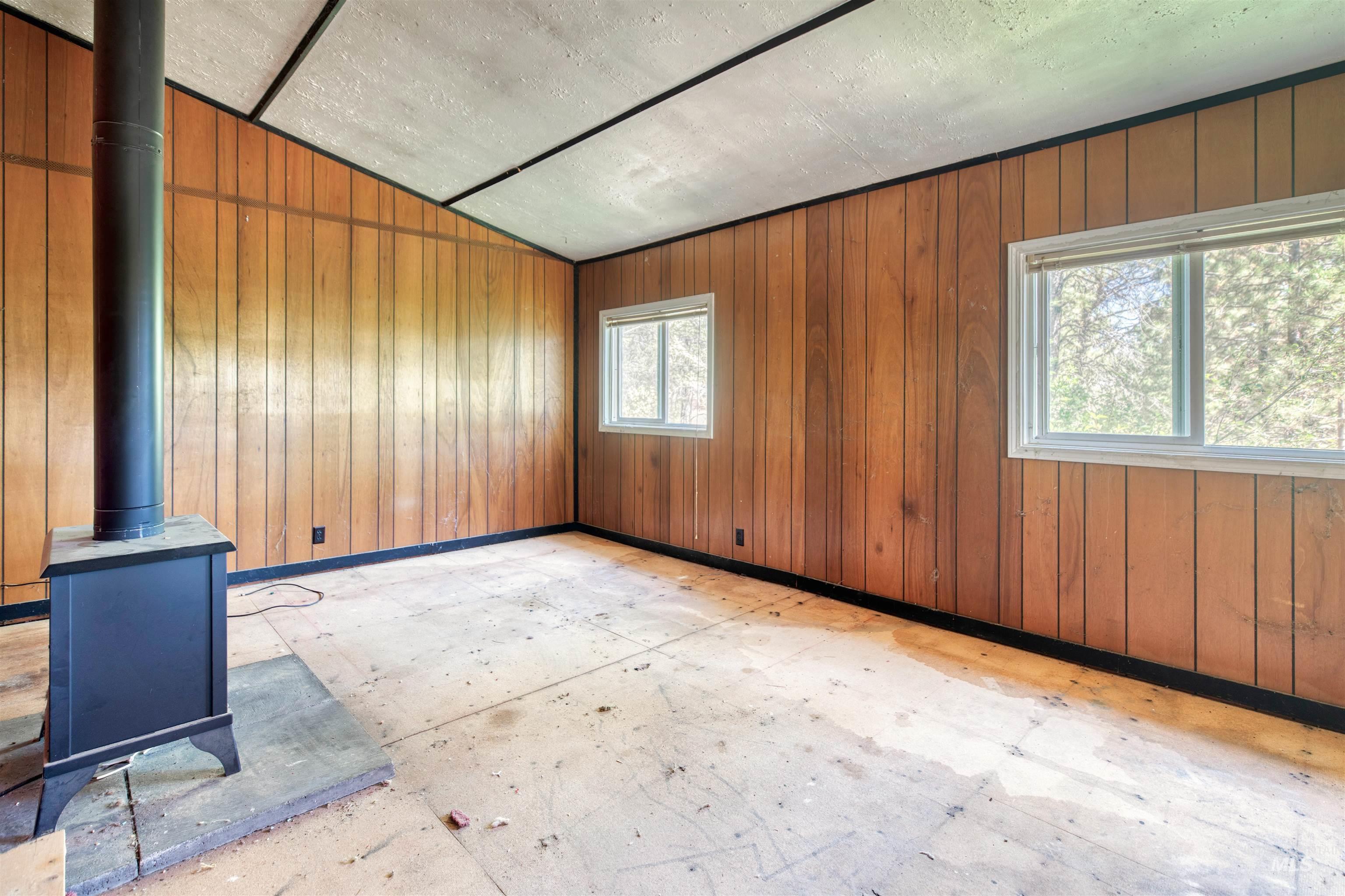175 Ranft Road Placerville, ID 83666 - Photo 6 of 28 Spare room featuring wooden walls and vaulted ceiling